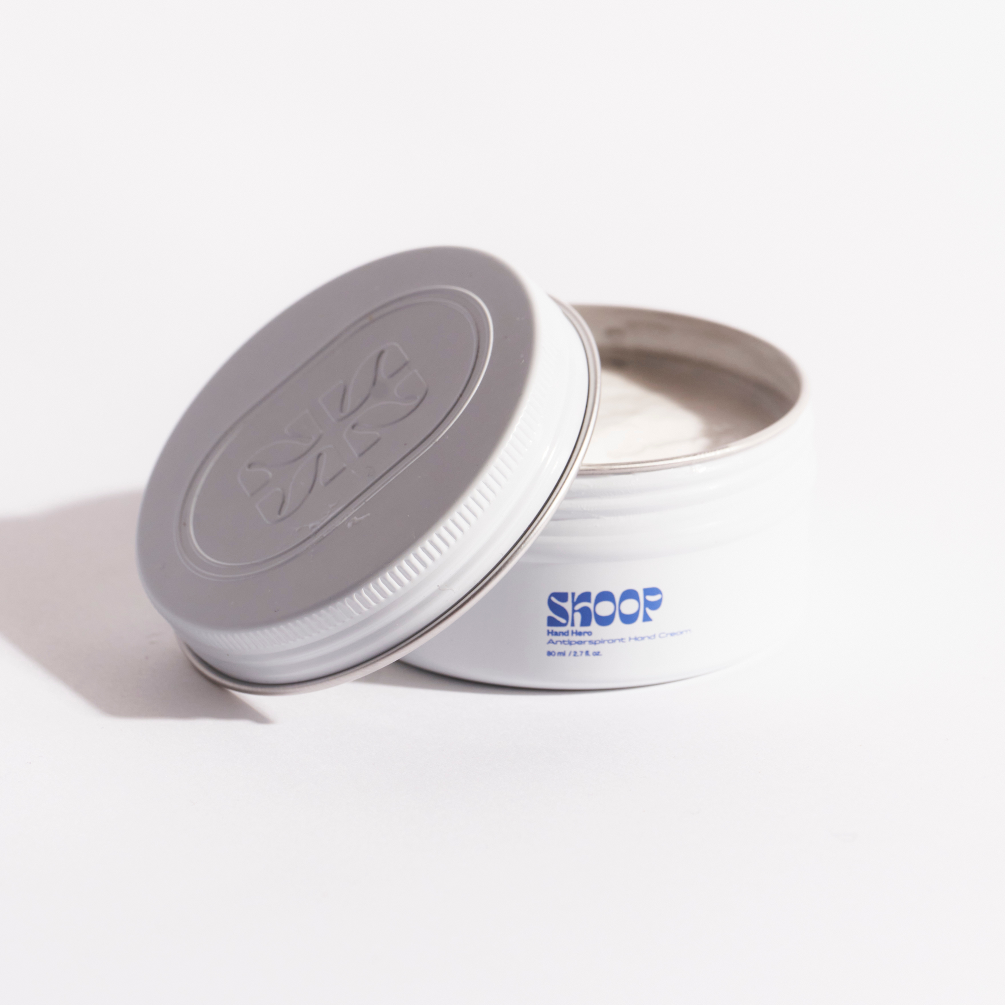 Skoop Skincare, Hand Hero Antiperspirant Hand Cream. Skoop Skincare Tin with Skoop logo visible. Lid off.